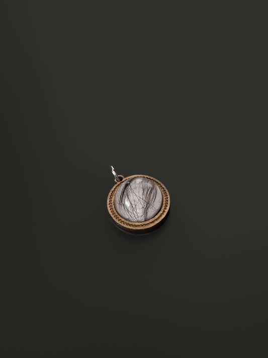 Close-up of wooden and resin memorial pendants on black background