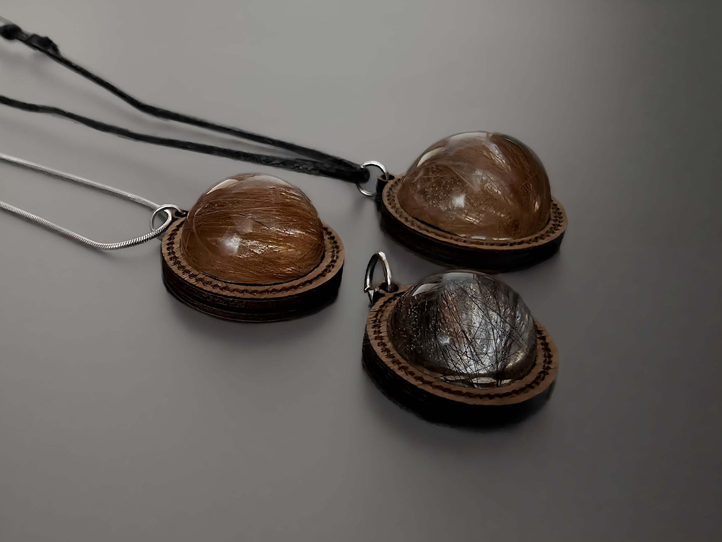 Close-up of wooden memorial pendants with hair inside