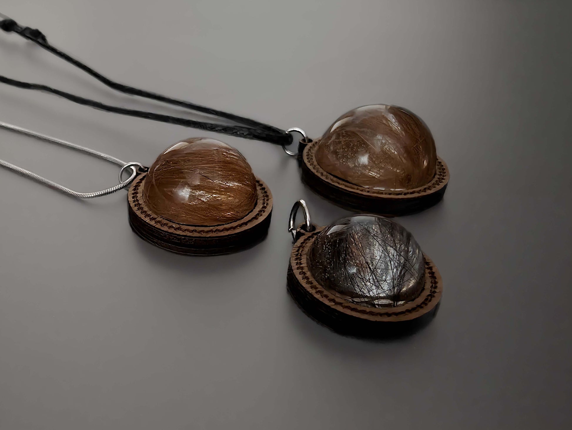 Close-up of wooden memorial pendants with hair inside