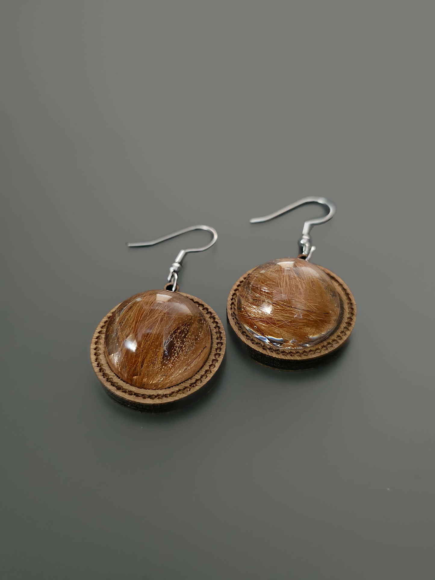 Wooden and resin dangle earrings on gray background