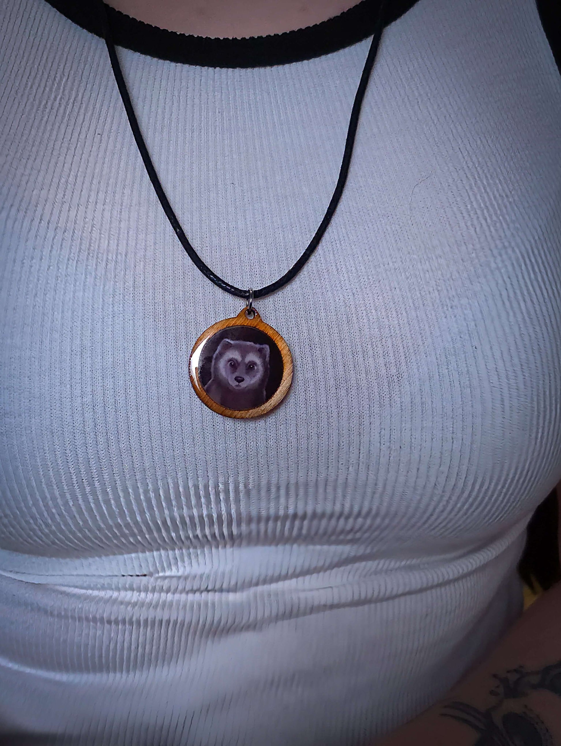 Wolf pendant necklace on white top, epoxy, Mäyrä