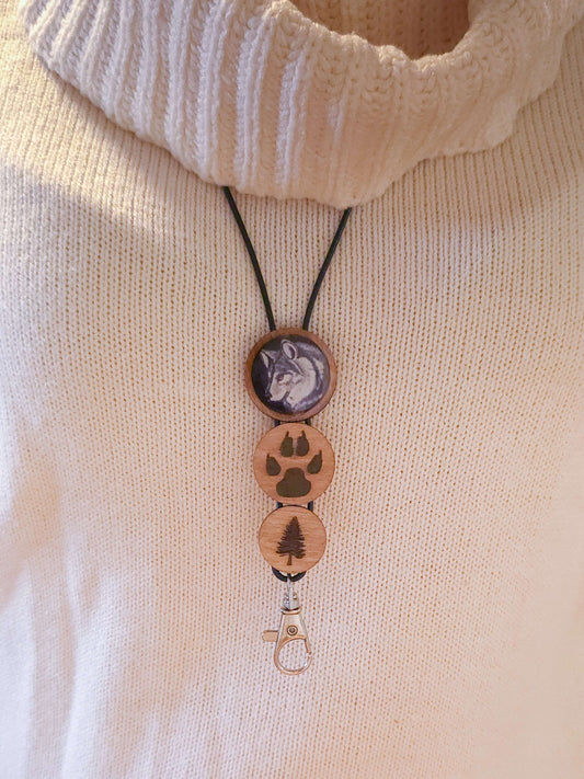 Wooden wolf keychain with paw print and tree designs