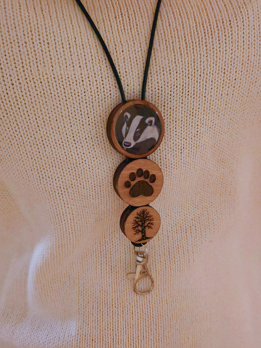 Wooden keychain with animal, paw print, and tree designs