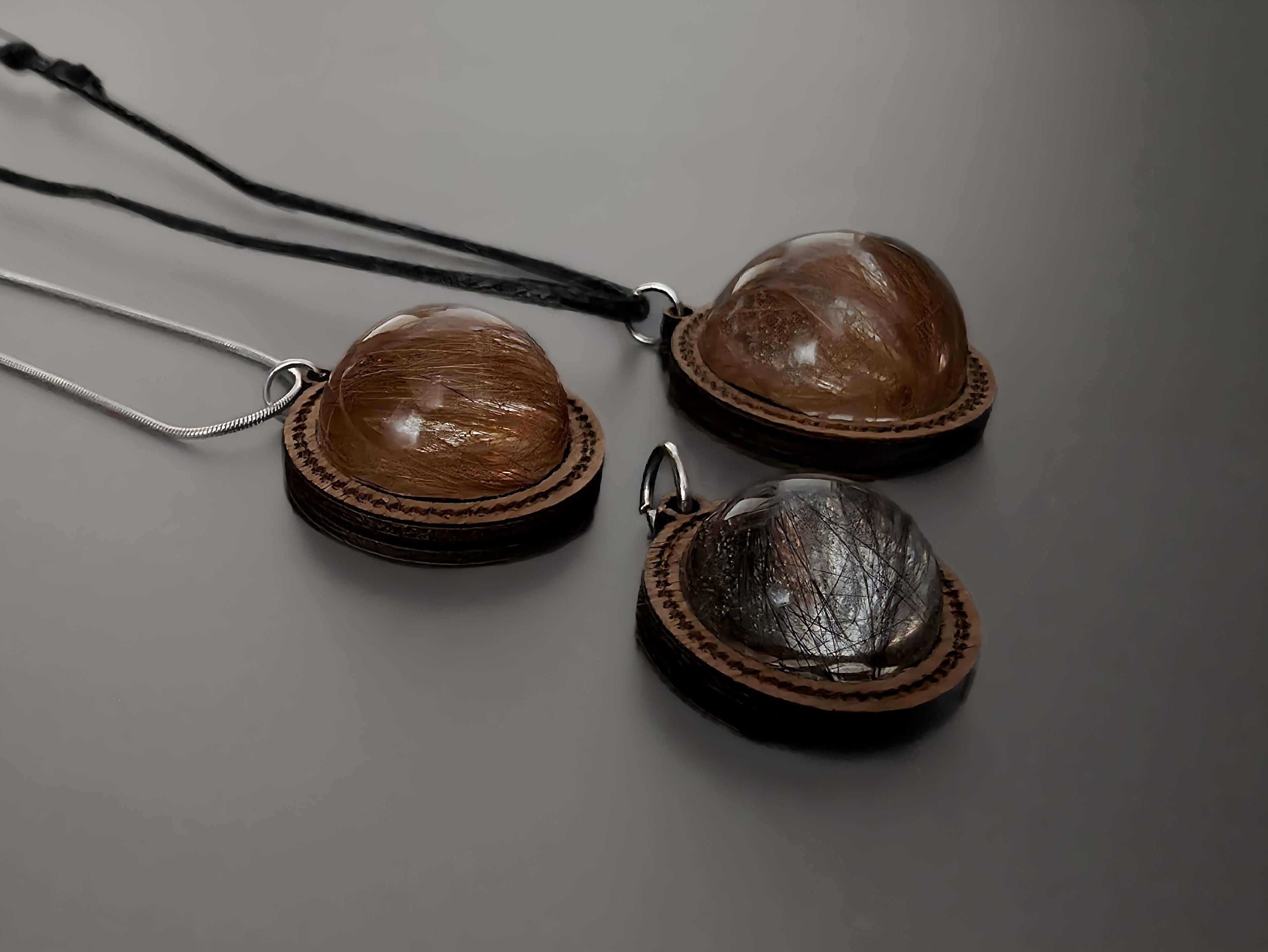 Close-up of wooden memorial pendants with hair inside