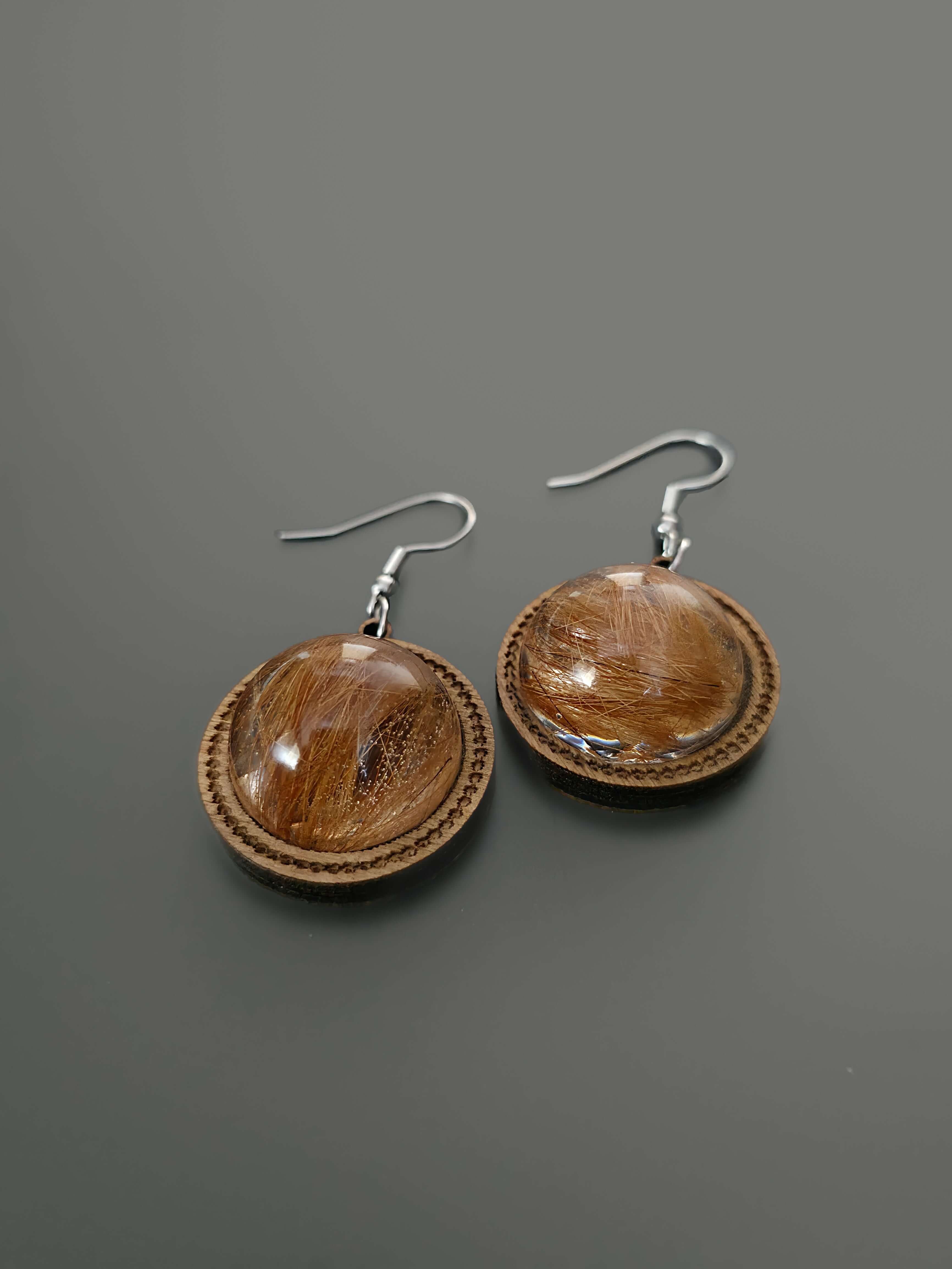 Wooden and resin dangle earrings on gray background