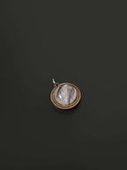 Close-up of wooden and resin memorial pendants on black background